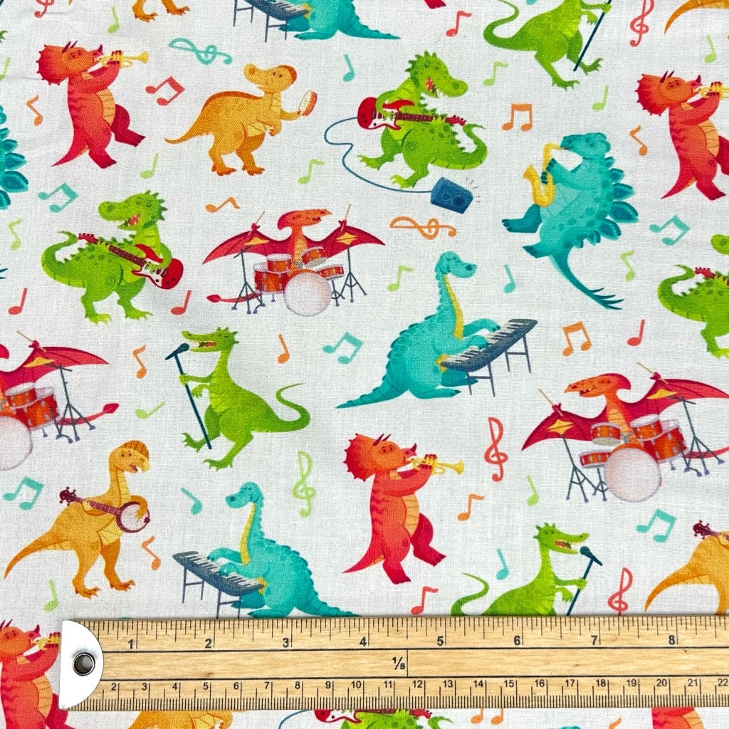 Dino Tunes on Ivory Cotton Fabric