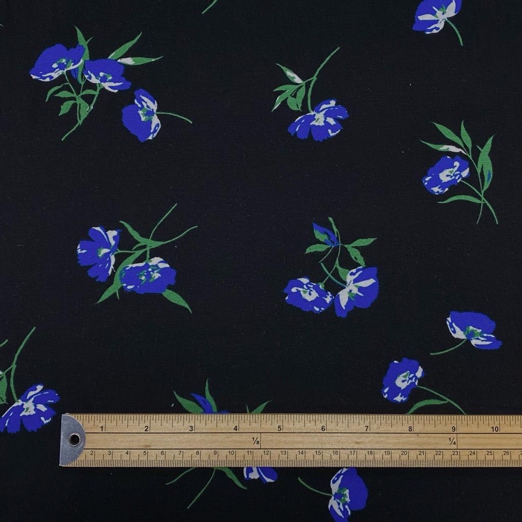 Blue Flowers on Black Cotton Jersey Fabric - Pound Fabrics