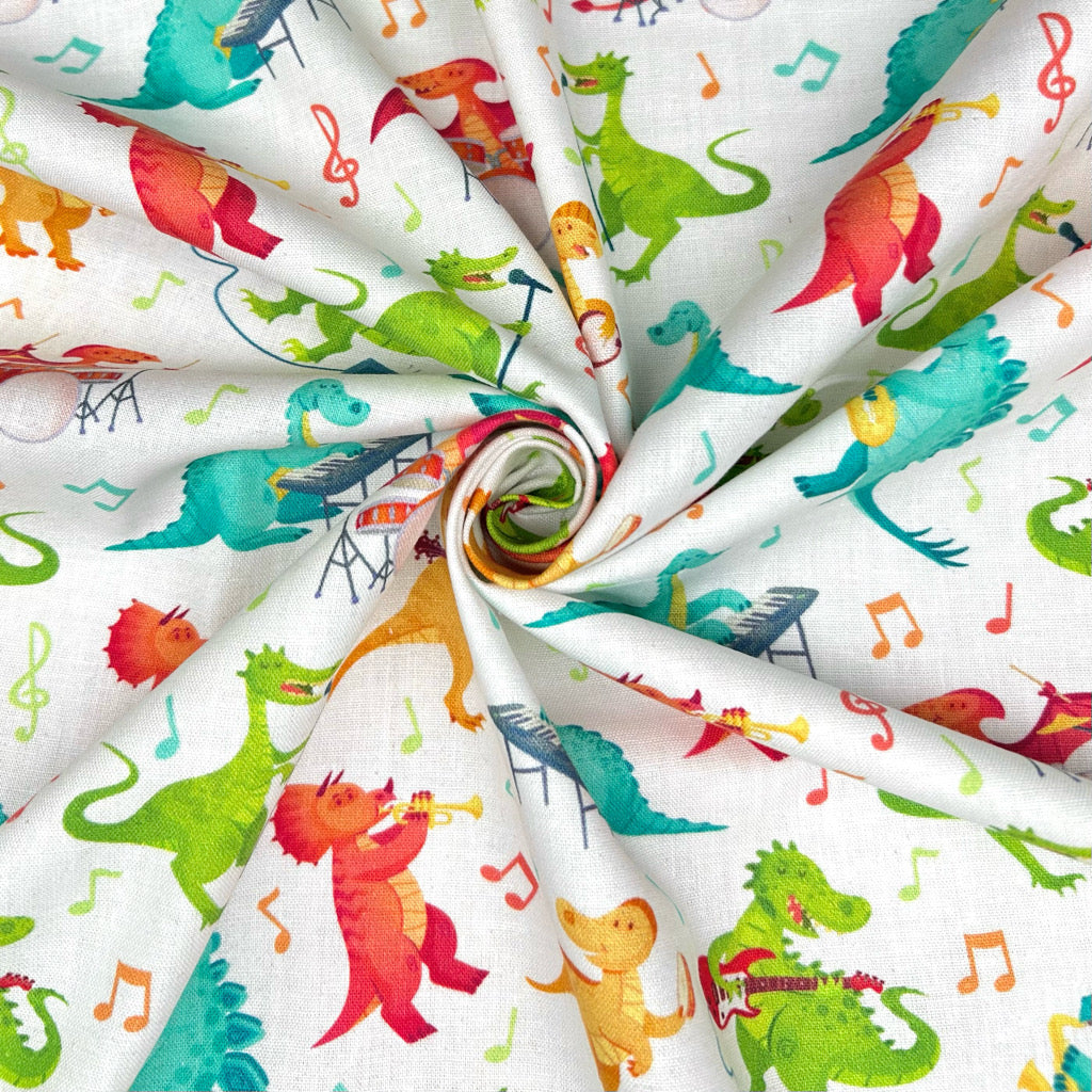 Dino Tunes on Ivory Cotton Fabric