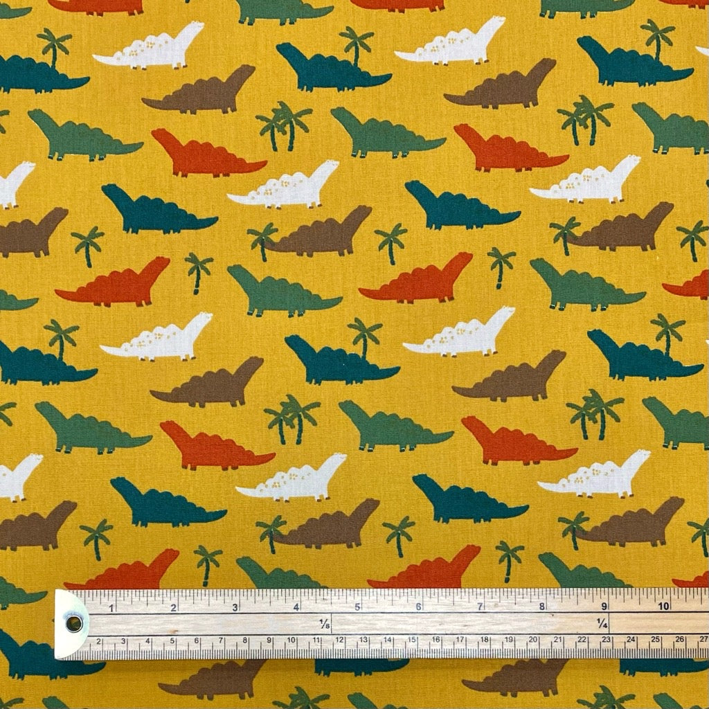 Colourful Dinosaurs on Ochre Cotton Poplin Fabric