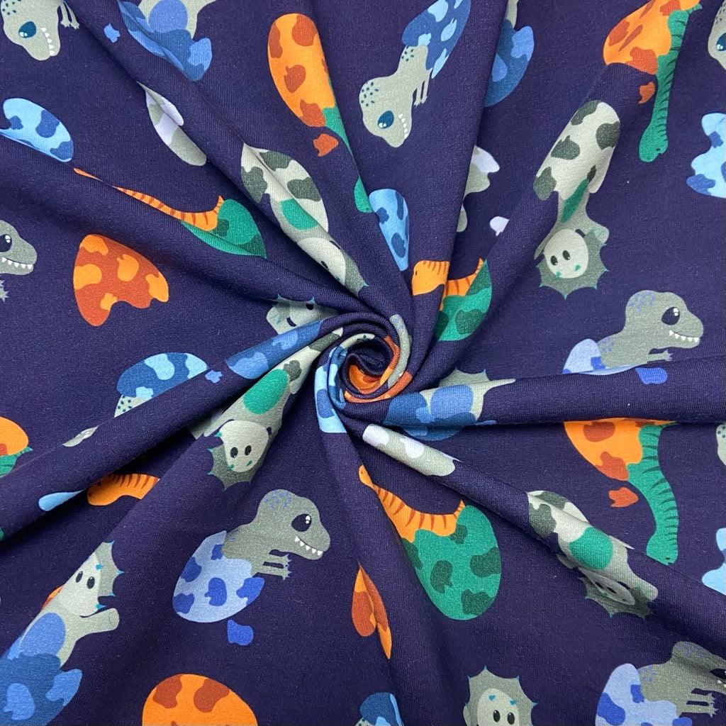 Hatching Dinosaurs Brushed Cotton Jersey Fabric - Pound Fabrics