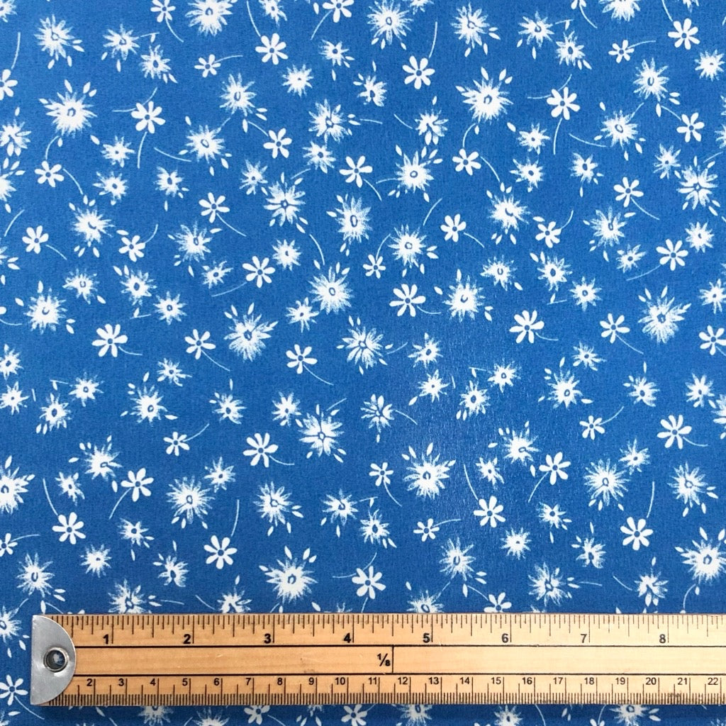 Single White Floral on Blue Polyester Crepe Fabric - Pound Fabrics