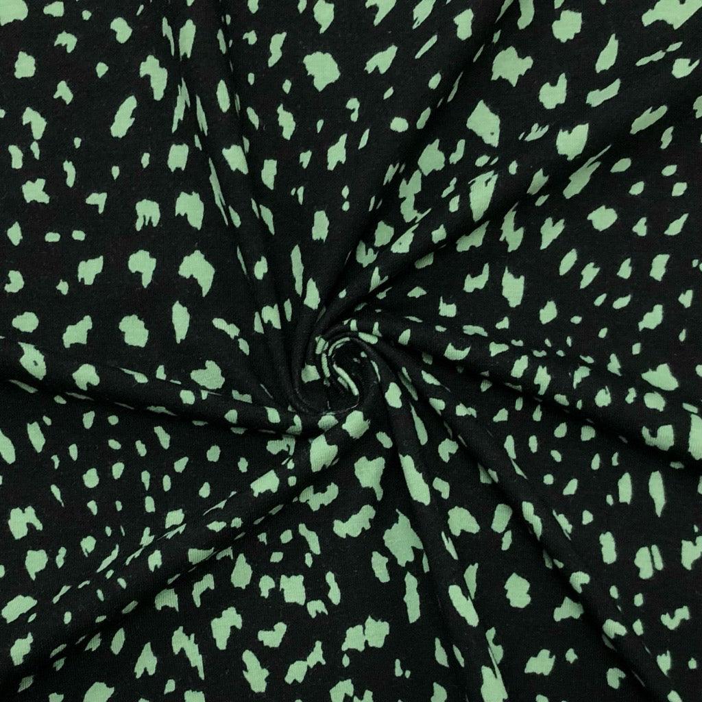 Green Animal Print on Black Cotton Jersey Fabric - Pound Fabrics