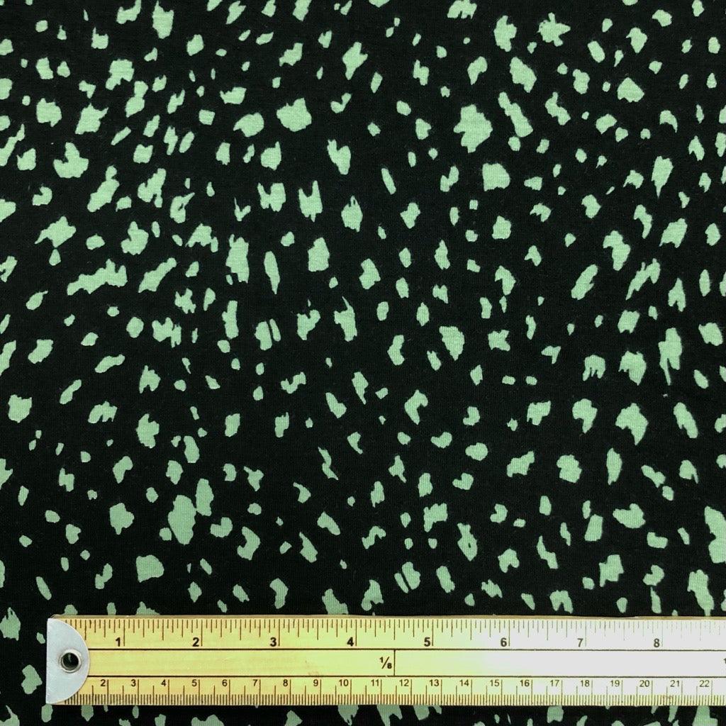 Green Animal Print on Black Cotton Jersey Fabric - Pound Fabrics